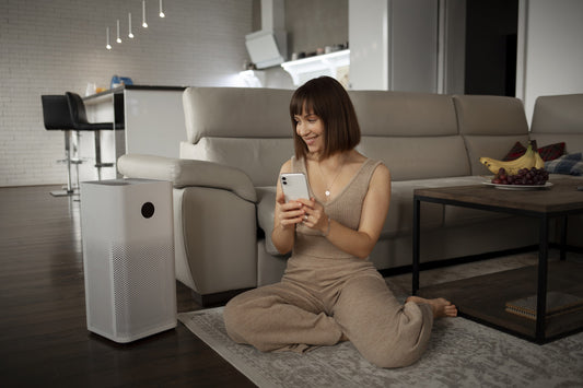 A woman enjoying clean air in her living room, emphasizing health benefits.