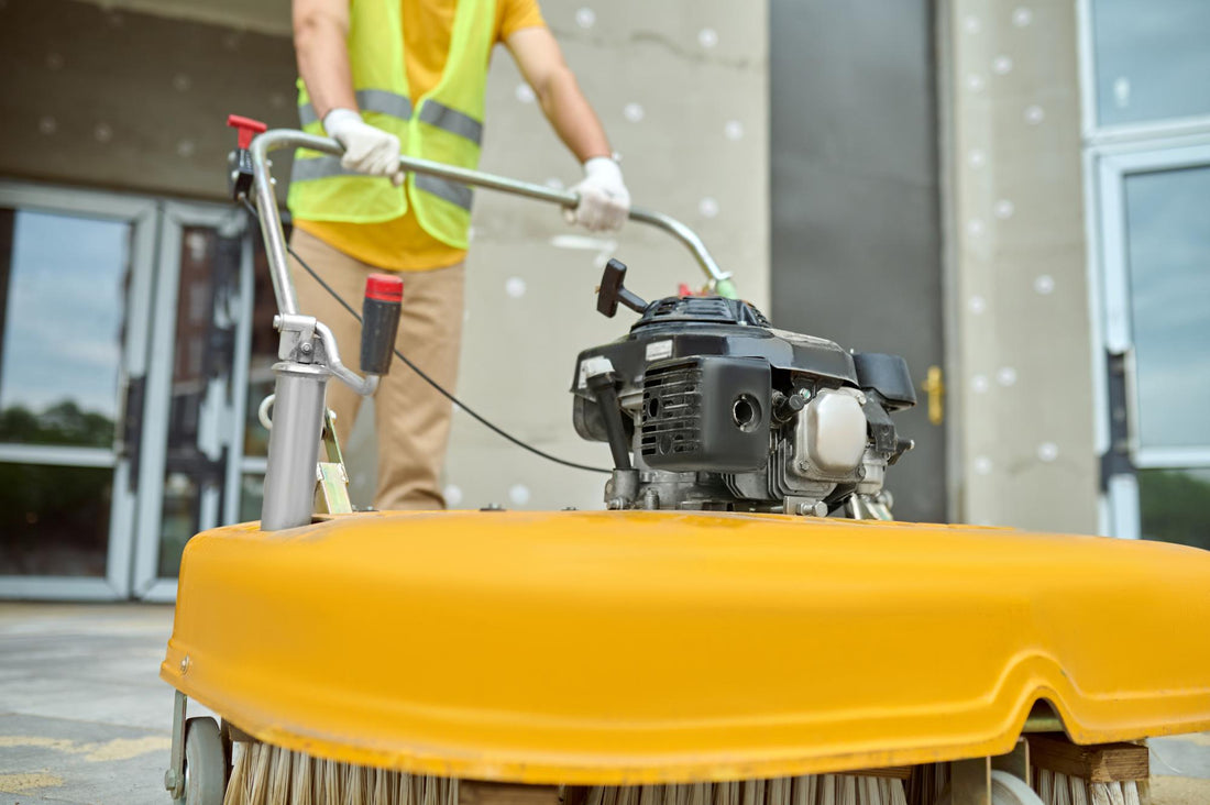 Worker using a floor scrubber to clean